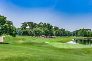 a view of a golf course with a pond at Modern Updated Elite 3BR Beach Home! Close to Golf Course & Beach! in Myrtle Beach