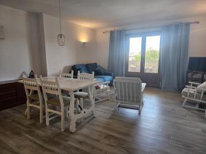 a living room with a table and chairs and a couch at Apartamento Bressol 3ºb in Port de Pollensa