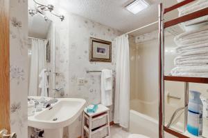 a white bathroom with a sink and a shower at Whispering Breeze Condo in Laguna Beach +17 photos