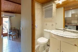 a bathroom with a toilet and a sink and a kitchen at Villa les Lauriers in Lioux +12 photos