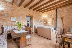 a living room with a table and a couch at Camp de Sitjar Sa Punta in Ses Salines
