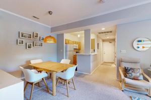 a kitchen and dining room with a wooden table and chairs at Captiva Sands at Eagles Landing --- 4500 Sand Piper Drive #4514 in Bald Eagle Village
