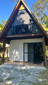 a house with a large window on the side of it at Refúgio da natureza in São Francisco do Sul