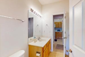 a bathroom with a sink and a toilet and a mirror at Captiva Sands at Eagles Landing --- 4500 Sand Piper Drive #4514 in Bald Eagle Village +12 photos