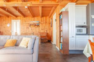 a living room with a couch and a kitchen at Beautiful house in nature for 20 people in Wetering