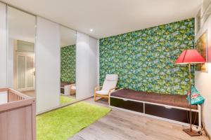 a room with a bed and a red lamp at Maison de la Plage in Sète