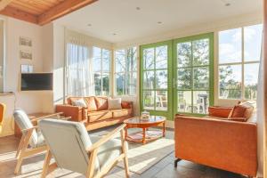 a living room with a couch and a table at Beautiful house in nature for 20 people in Wetering