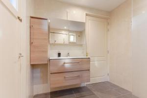 a bathroom with a sink and a mirror at Beautiful house in nature for 20 people in Wetering +33 photos