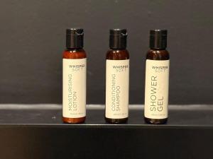 three bottles of cough syrup sitting on a shelf at Stylish Cape Town Apartment - Table Mountain View in Cape Town +26 photos