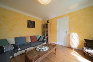 a living room with a couch and a coffee table at Luchon Maison Flor in Luchon
