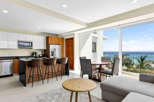 a kitchen and living room with a view of the ocean at Blue Wave Hideaway at Quinta Banderas Bay in Bucerías