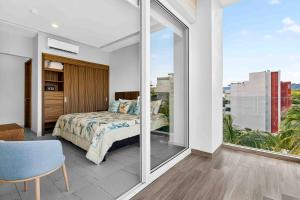 a bedroom with a bed and a large window at Blue Wave Hideaway at Quinta Banderas Bay in Bucerías +25 photos