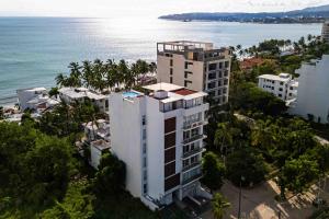 an aerial view of a building next to the ocean at Blue Wave Hideaway at Quinta Banderas Bay in Bucerías