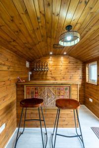 two stools in a room with wooden walls at Karazo LTD - Luxurious contractor and family friendly 4 bedroom in Croydon with Parking in Croydon