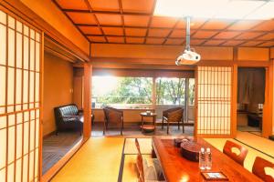 a living room with a table and a dining room at 熱海の隠れ里 in Atami