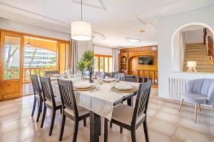 a dining room with a table and chairs at Villa Tossals in El Arenal +27 photos