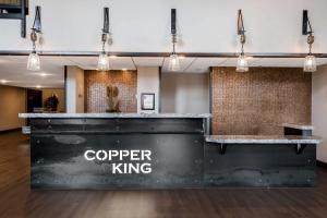 a lobby with a counter with the words copper king at Copper King Convention Center, an Ascend Collection Hotel in Butte +52 photos