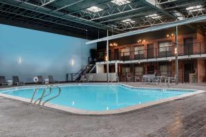 a large swimming pool in the middle of a building at Copper King Convention Center, an Ascend Collection Hotel in Butte