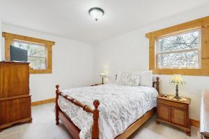 a bedroom with a bed and a tv and a window at Woodland Chalet in Boyds Creek