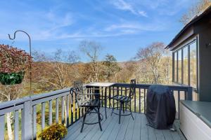 a balcony with two chairs and a table on it at The Glen C10 in Sugar Mountain