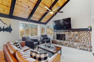 a living room with a couch and a fireplace at The Glen C10 in Sugar Mountain