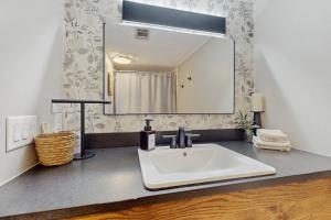 a bathroom with a white sink and a mirror at The Glen C10 in Sugar Mountain +17 photos
