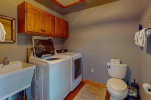 a bathroom with a washing machine and a toilet at Camp Farrell in Manitowish Waters +45 photos