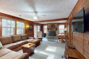 a living room with a couch and a tv at Camp Farrell in Manitowish Waters