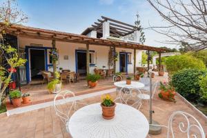 a patio of a house with tables and chairs at Quinta das Achadas - Bouganvillea in Lagos
