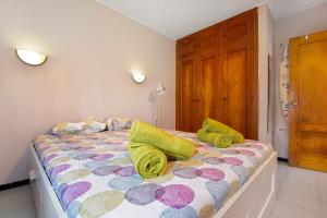 a bedroom with a bed with colorful pillows on it at Casa Raquel 2 in Costa de Antigua +15 photos
