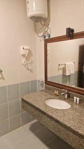 a bathroom with a sink and a mirror at Rowaa Lindy Hotel Makkah in Makkah