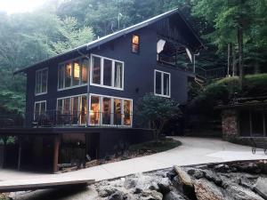 a large blue house with glass doors and windows at The Loft at Old Falls in Primm Springs