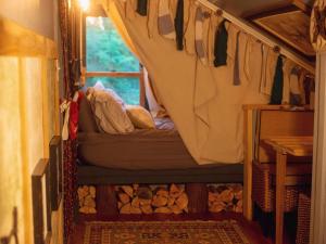 a room with a bed with a window in a train at The Loft at Old Falls in Primm Springs