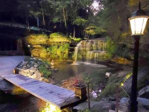 a street light next to a pond with a bridge at The Loft at Old Falls in Primm Springs +7 photos