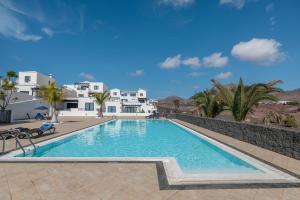 a swimming pool in front of a villa at Casa Bidasoa 35 in Playa Blanca