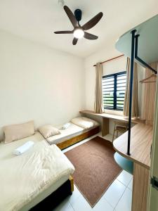 a bedroom with two beds and a ceiling fan at Kuntum Homestay in Seri Iskandar