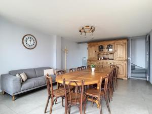a dining room with a table and chairs and a couch at Les Caboches de Garanche in Charentay