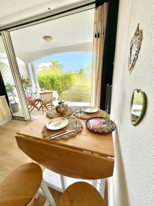 a table in a room with a large window at Casa Pombo SXM in Anse Marcel  +21 photos