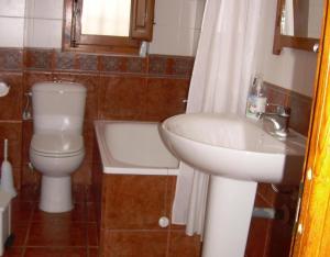 a bathroom with a toilet and a sink at Cortijo El Paso in Vélez Blanco