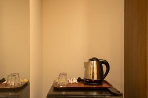 a tea kettle on a table in a room at Pyraking Pyramids View Hotel in Giza