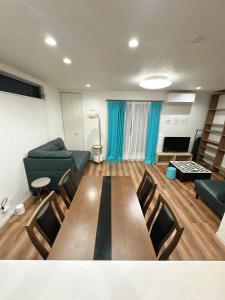 a living room with a couch and a table at Kasilin House in Osaka
