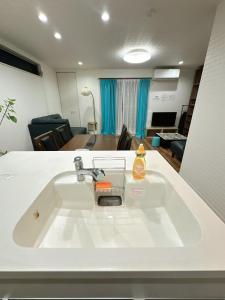 a white sink in a room with a living room at Kasilin House in Osaka +40 photos