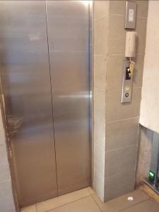 an elevator in a building with a metal door at Home sweet home in Nairobi