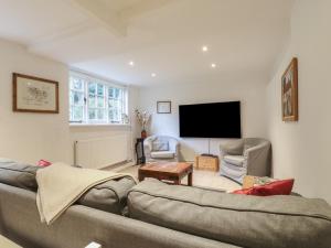 ein Wohnzimmer mit Couch und Flachbildfernseher in der Unterkunft Cherry Cottage in Withyham