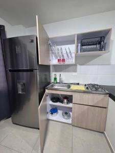 a kitchen with a stainless steel refrigerator and a sink at Apartaestudio 101 cómodo y Moderno in Tuluá +7 photos