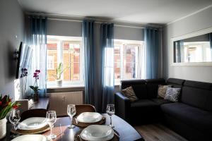 a living room with a table and a couch at Apartamenty Szlachecki I Pod Artusem in Gdańsk