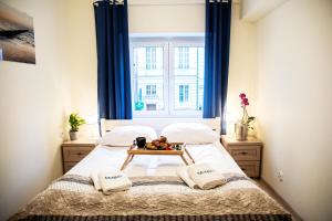 a bedroom with a bed with a tray of fruit on it at Apartamenty Szlachecki i Pod Artusem in Gdańsk