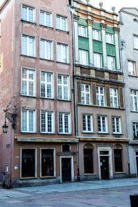 a group of tall buildings on a city street at Apartamenty Szlachecki I Pod Artusem in Gdańsk