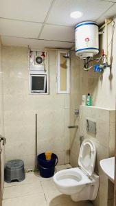 a small bathroom with a toilet and a microwave at Luxe Homes 1Bhk Luxury AirB&B Flat in Mohali