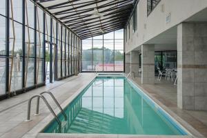 a large swimming pool in a building with windows at Waikiki #302 in Ocean City